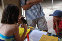boy watching girl pet bird